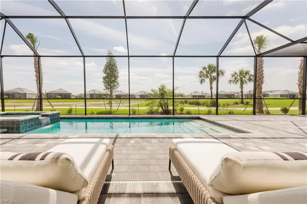 a view of a patio with a table and chairs