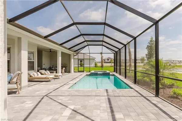 a view of swimming pool with a couches and table