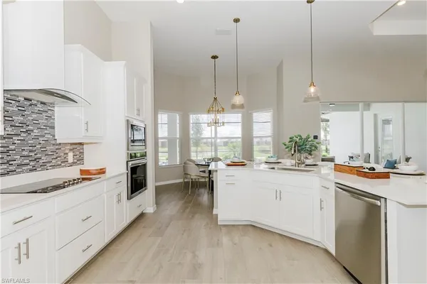 a kitchen with white cabinets and white appliances
