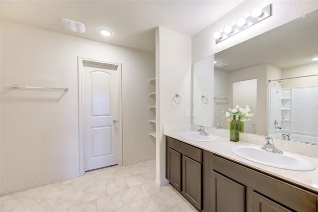 a bathroom with a double vanity sink and a mirror