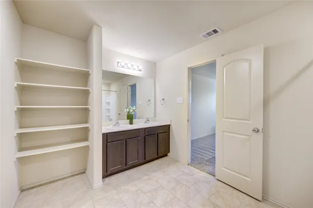 a room with a cabinets and a window