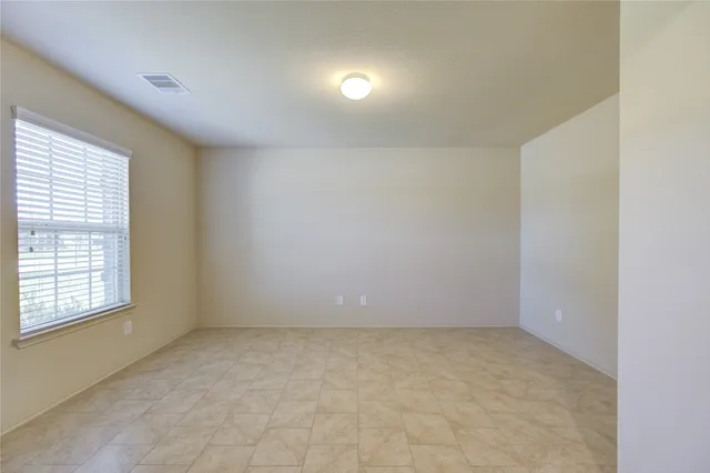 an empty room with a empty space and window