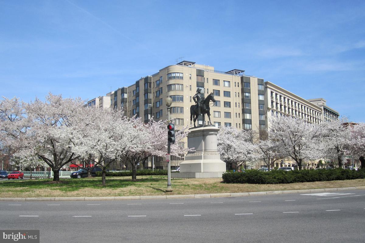 a large building with a trees in the background