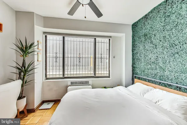 a bedroom with a bed and a window