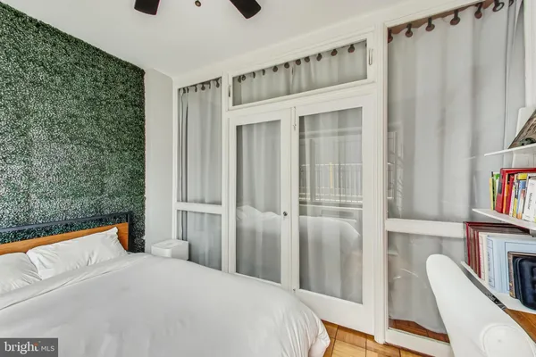a bedroom with a bed and a window