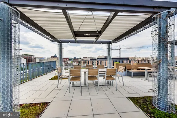 a group of chairs sitting in patio with a fireplace