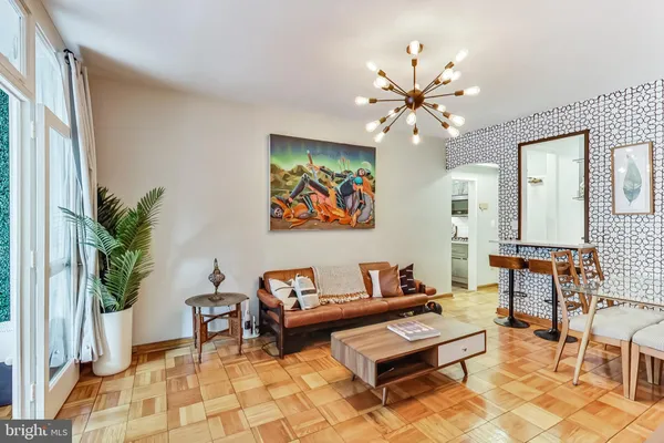 a living room with furniture and a chandelier