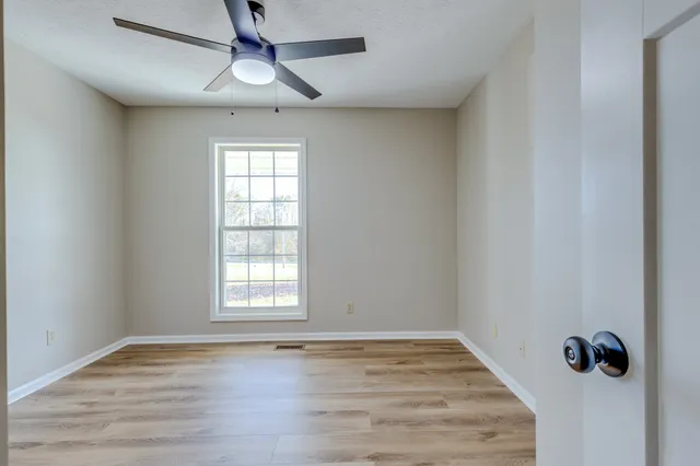 wooden floor in an empty room with a window