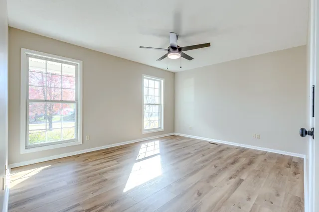 wooden floor in an empty room with a window