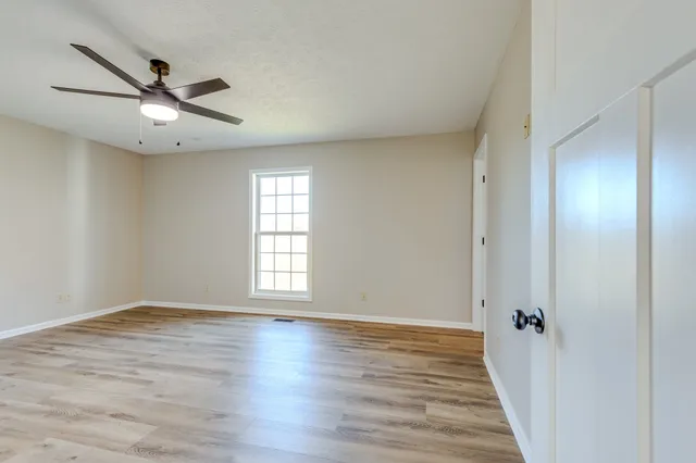a bathroom with a granite countertop sink a mirror and shower