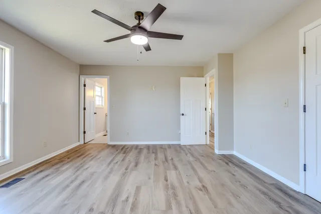 a room with a sink and wooden floor
