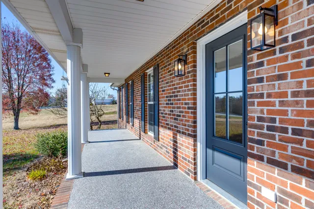 a view of a livingroom with a ceiling fan wooden floor and a ceiling fan