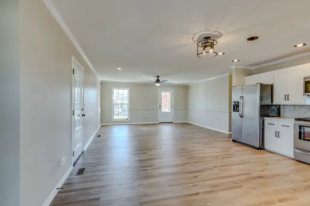 a kitchen with stainless steel appliances granite countertop a sink stove and wooden floor