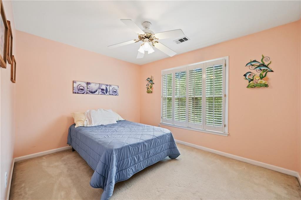 1011 Crofton Landing Suwanee, GA 30024 - Photo 13 of 25 a bedroom with a bed and a window