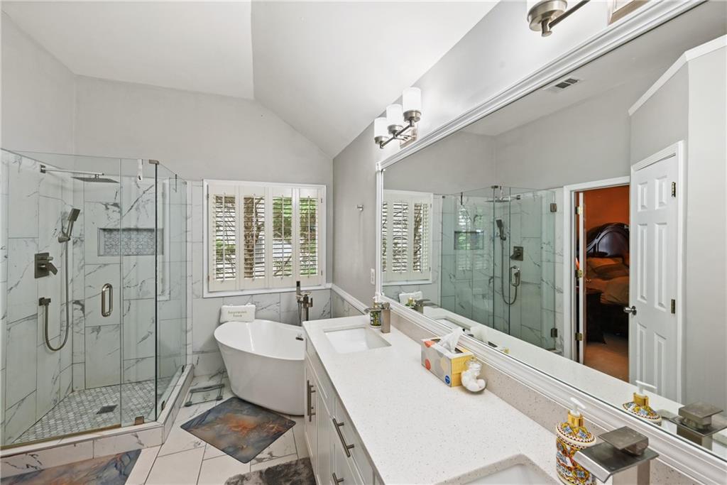 1011 Crofton Landing Suwanee, GA 30024 - Photo 14 of 25 a bathroom with a sink mirror and shower