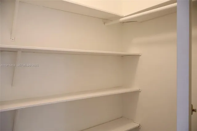 a view of a livingroom with an empty space and a window