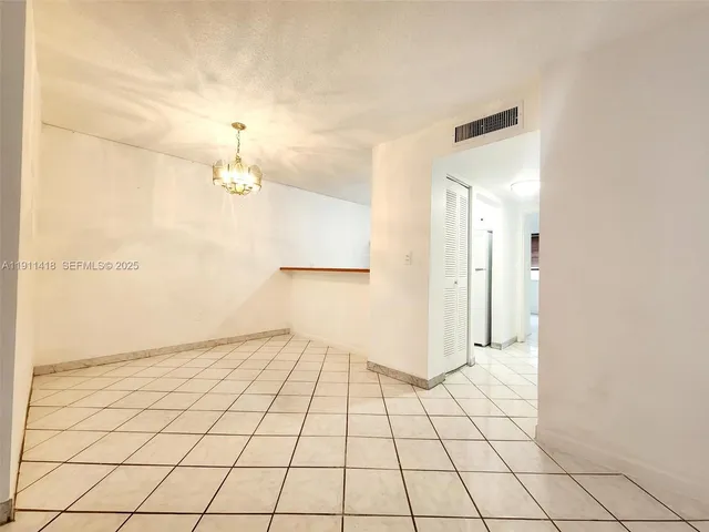 a bathroom with a granite countertop toilet and a sink