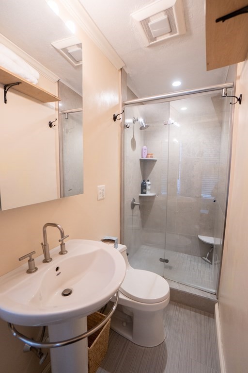 11 Irving Street, Unit 6 Boston, MA 02114 - Photo 11 of 14 a bathroom with a sink toilet and shower