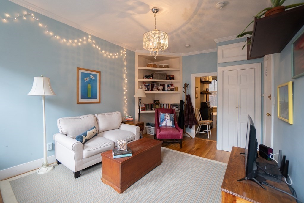 11 Irving Street, Unit 6 Boston, MA 02114 - Photo 3 of 14 a living room with furniture a dining table and a window