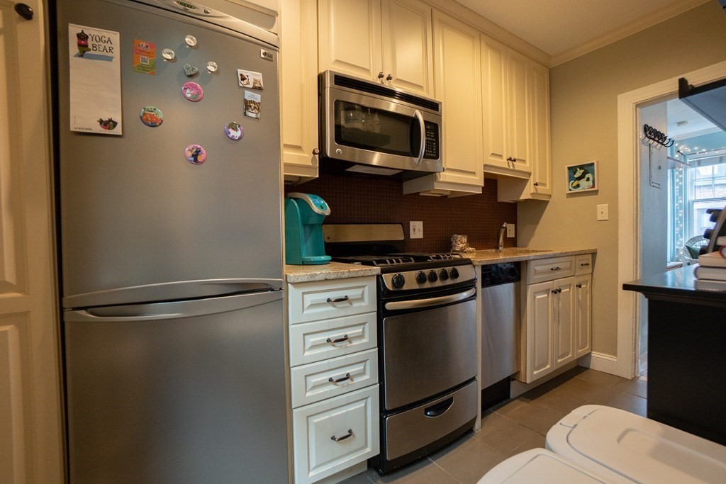 11 Irving Street, Unit 6 Boston, MA 02114 - Photo 6 of 14 a kitchen with stainless steel appliances a refrigerator stove and microwave