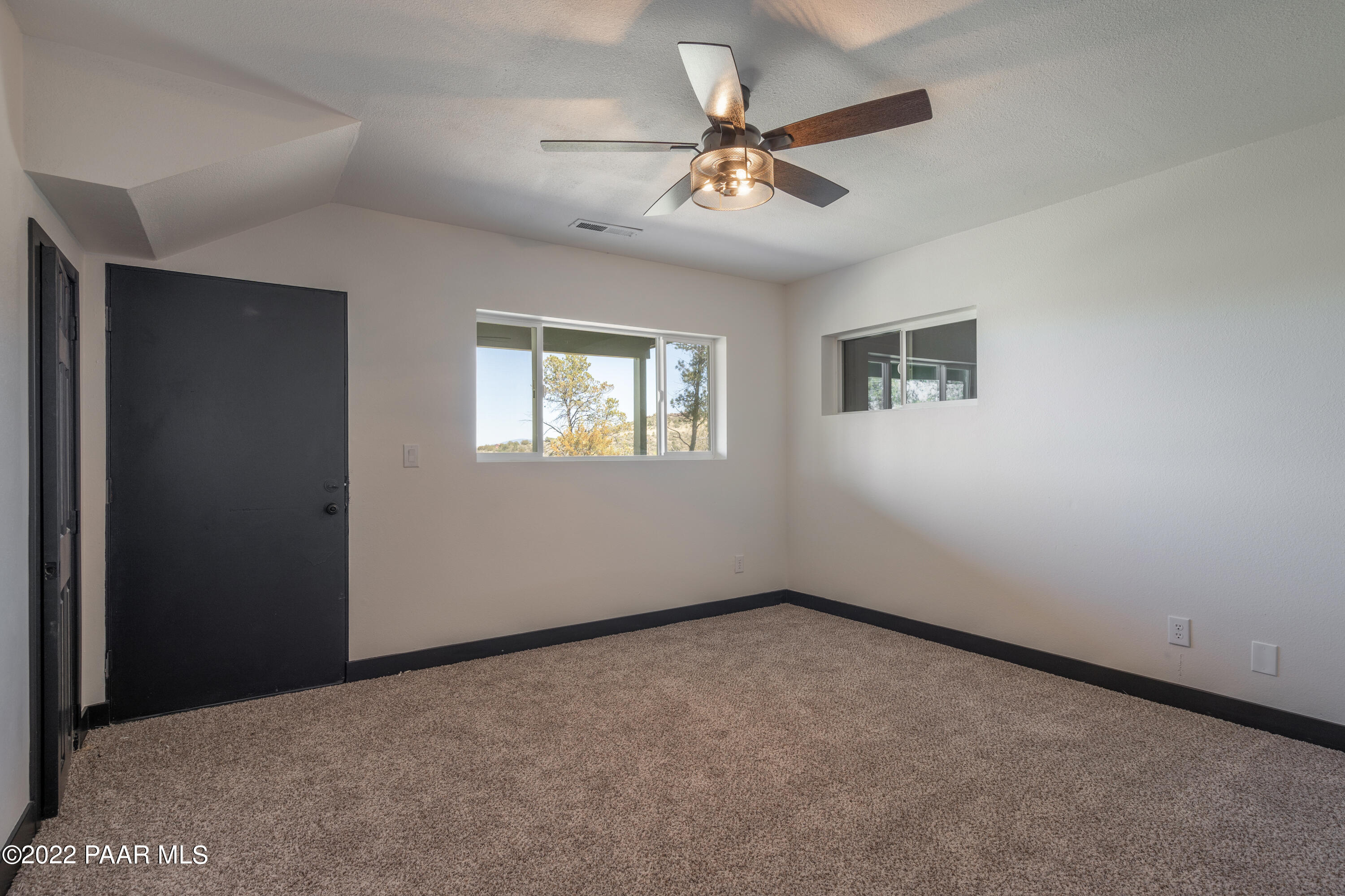 2615 Ridge Road Prescott, AZ 86301 - Photo 18 of 29 a view of a big room with windows and chandelier fan