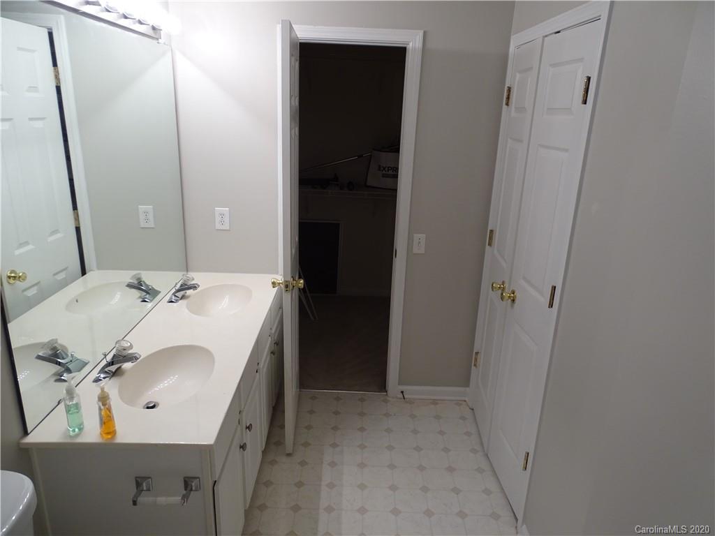 6929 Rothchild Drive Charlotte, NC 28270 - Photo 15 of 20 a en suite bathroom with a sink and mirror