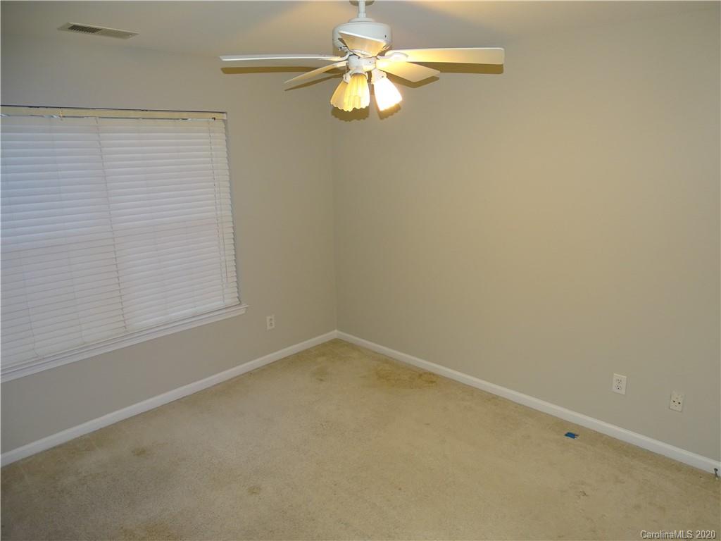 6929 Rothchild Drive Charlotte, NC 28270 - Photo 17 of 20 an empty room with a window and a fan