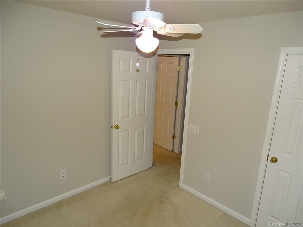 6929 Rothchild Drive Charlotte, NC 28270 - Photo 19 of 20 a view of a hallway with chandelier fan
