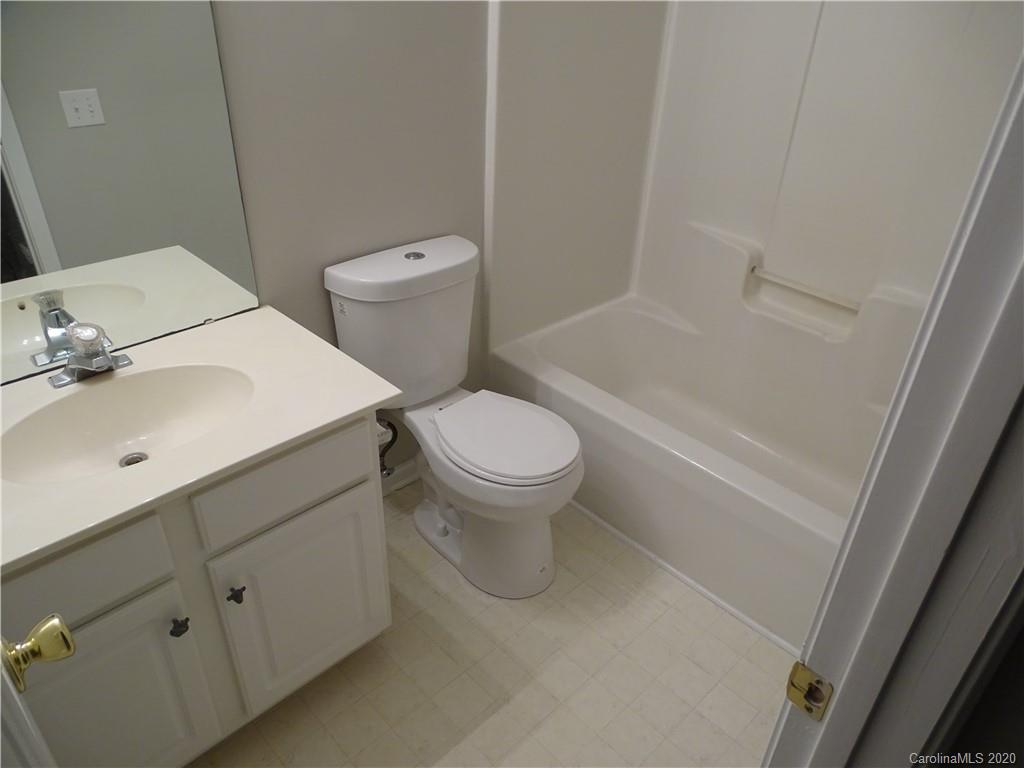 6929 Rothchild Drive Charlotte, NC 28270 - Photo 20 of 20 a white toilet sitting next to a bathroom sink