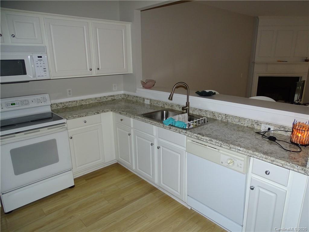 6929 Rothchild Drive Charlotte, NC 28270 - Photo 8 of 20 a kitchen with granite countertop white cabinets and white appliances