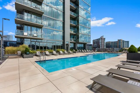 a view of a swimming pool with outdoor seating