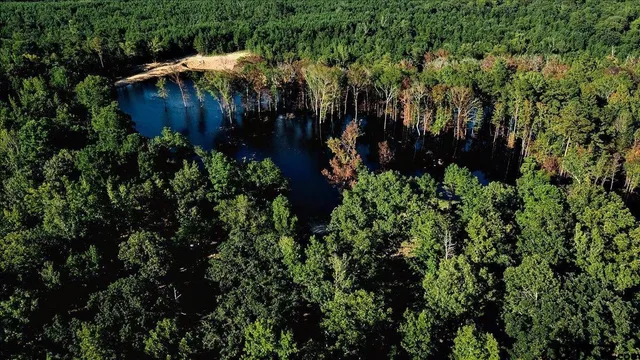 an aerial view of house with yard and outdoor seating