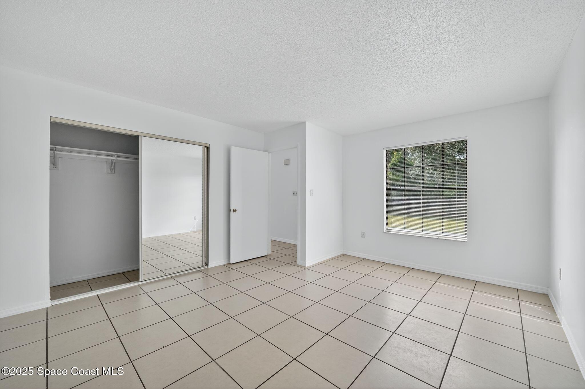 410 Thor Avenue Southeast, Unit 103 Palm Bay, FL 32909 - Photo 14 of 19 a view of an empty room and window