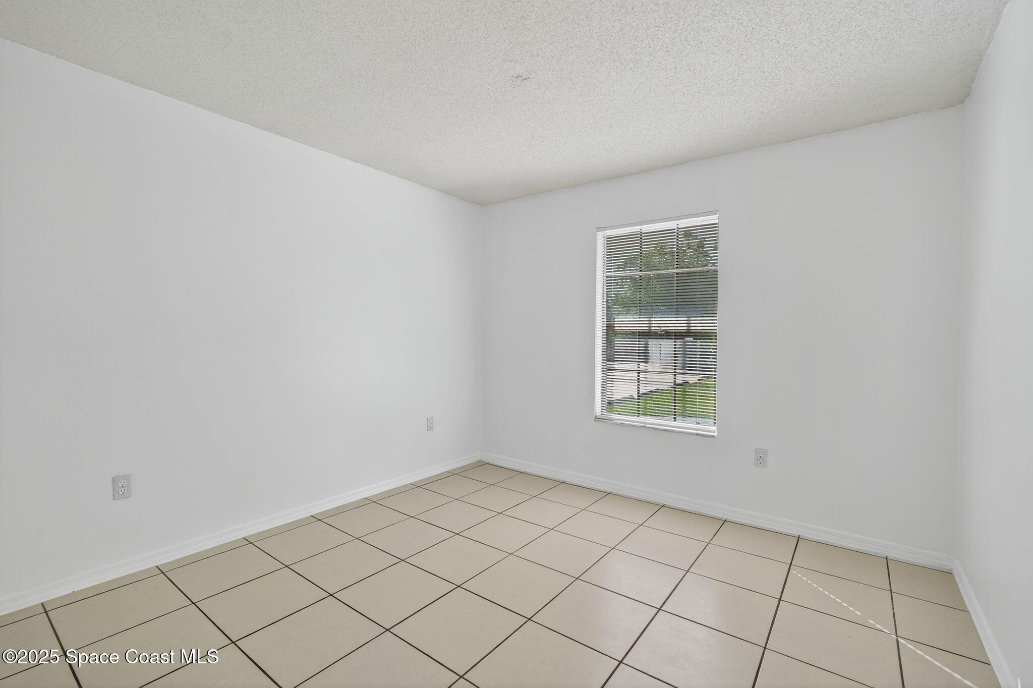 410 Thor Avenue Southeast, Unit 103 Palm Bay, FL 32909 - Photo 16 of 19 a view of an empty room and window