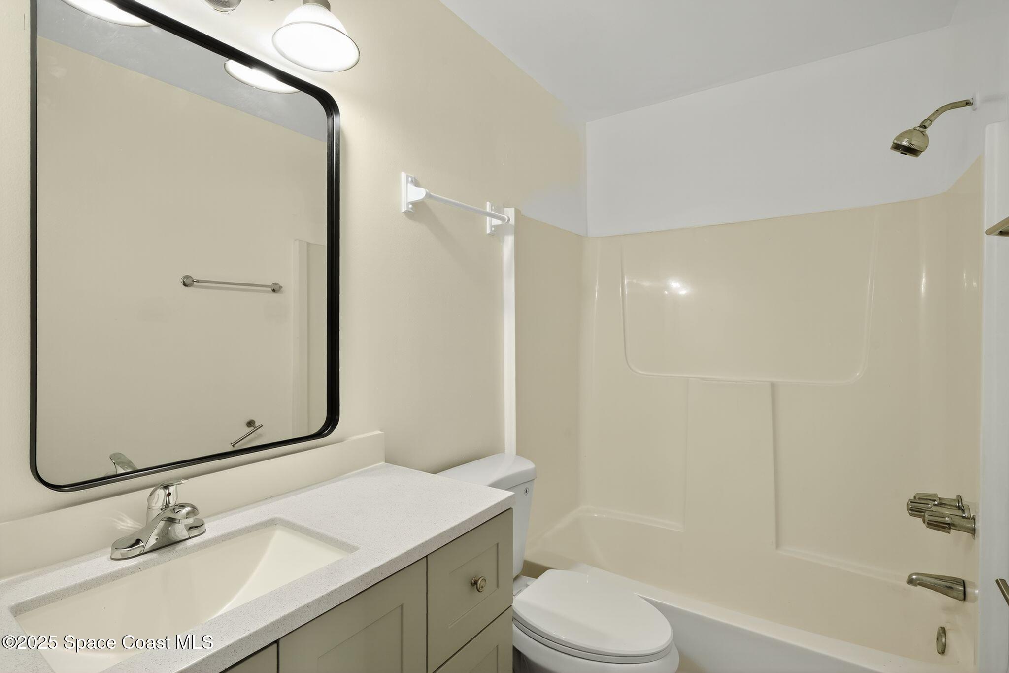 410 Thor Avenue Southeast, Unit 103 Palm Bay, FL 32909 - Photo 17 of 19 a bathroom with a sink toilet vanity and shower
