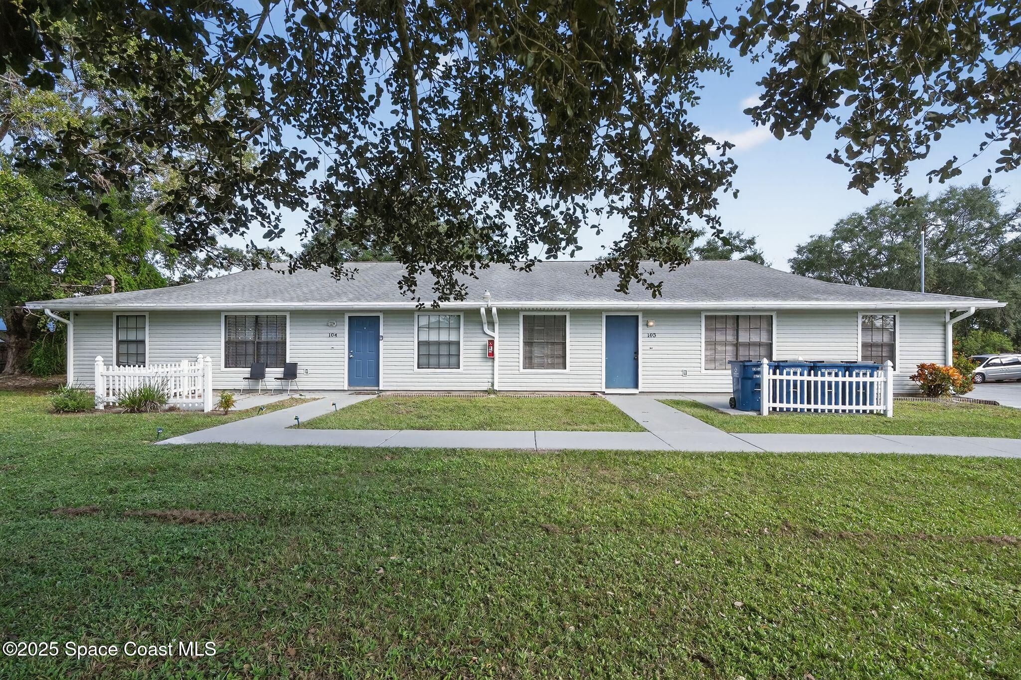 410 Thor Avenue Southeast, Unit 103 Palm Bay, FL 32909 - Photo 2 of 19 a front view of house with yard and green space