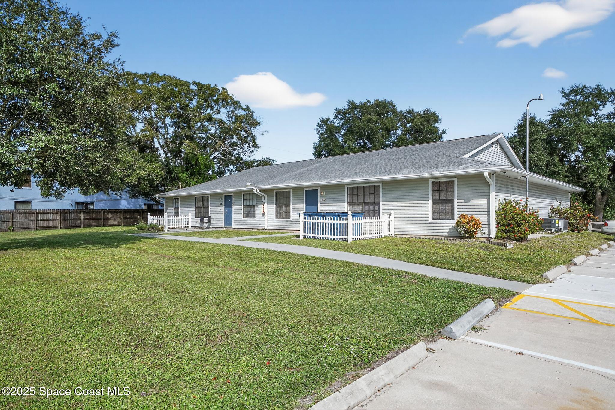 410 Thor Avenue Southeast, Unit 103 Palm Bay, FL 32909 - Photo 4 of 19 a front view of a house with a garden
