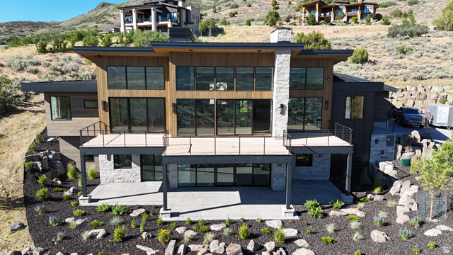 1918 Chimney Rock Road Heber City, UT 84032 - Photo 3 of 74 Contemporary architectural design featuring extensive window walls, wood-paneled siding, and stone accents