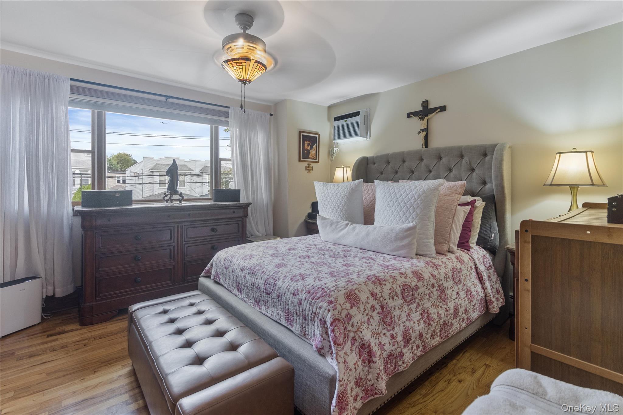 69-24 68th Place Queens, NY 11385 - Photo 12 of 26 a bedroom with a bed mirror and window