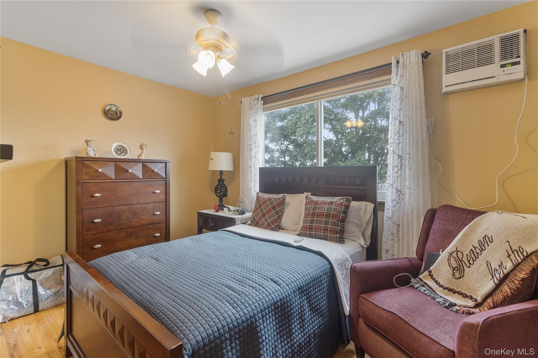 69-24 68th Place Queens, NY 11385 - Photo 14 of 26 a bedroom with a bed and window