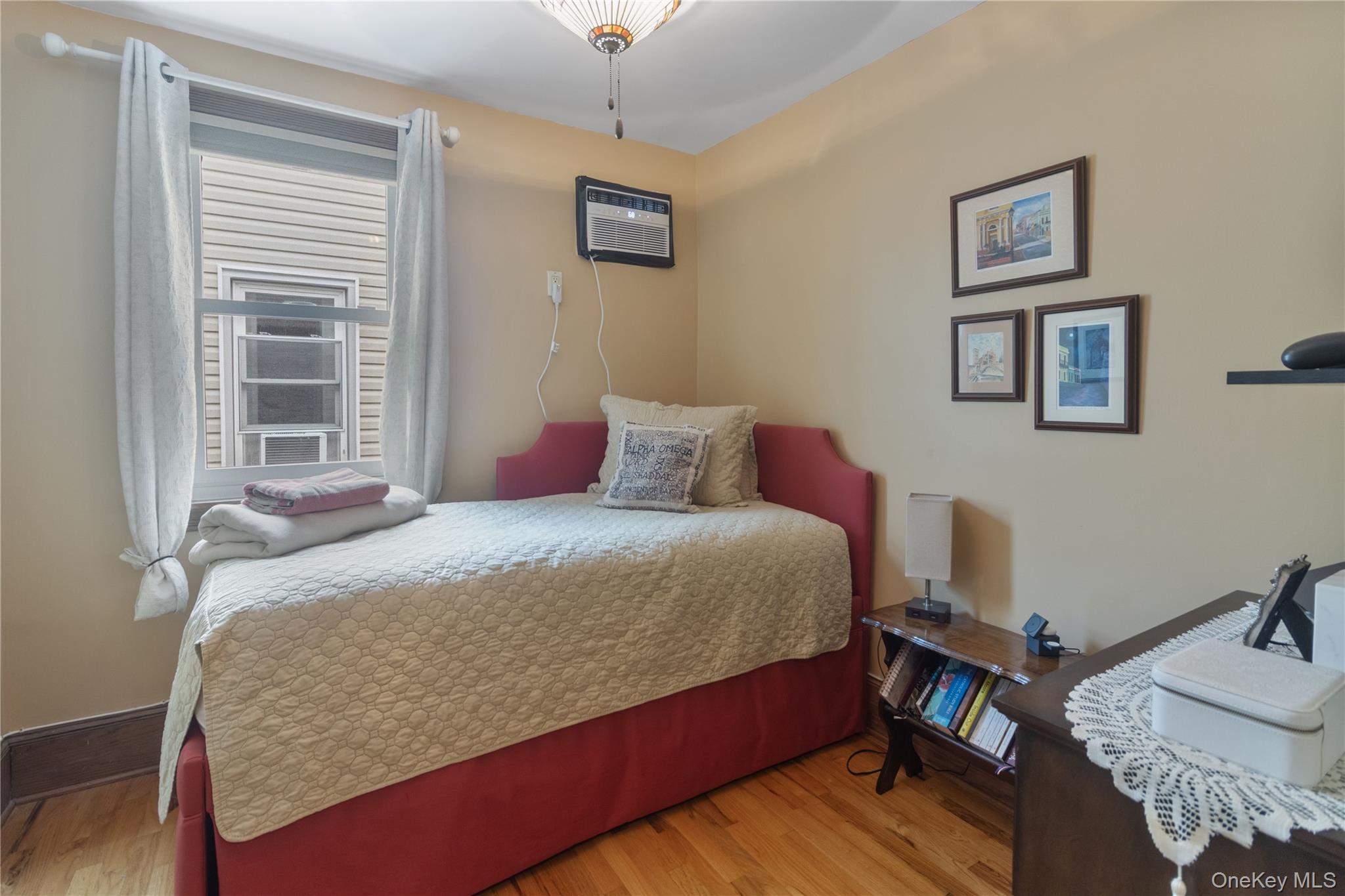 69-24 68th Place Queens, NY 11385 - Photo 16 of 26 a bedroom with a bed and wooden floor