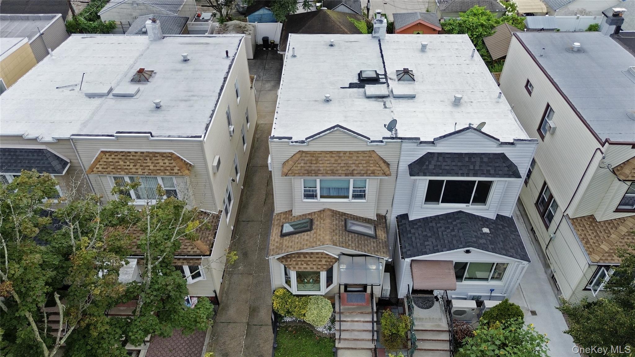 69-24 68th Place Queens, NY 11385 - Photo 24 of 26 an aerial view of a house with a yard
