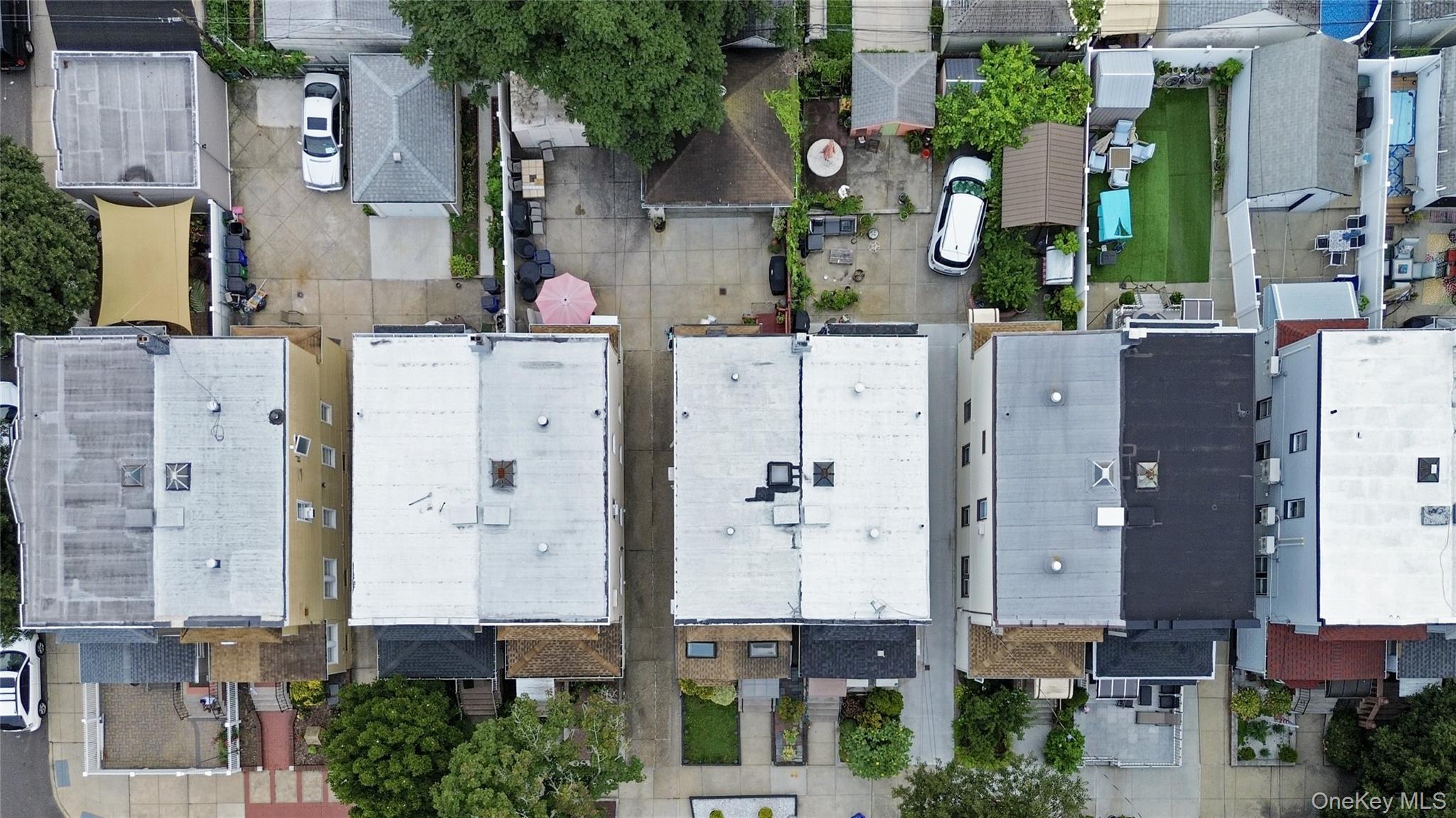 69-24 68th Place Queens, NY 11385 - Photo 25 of 26 front view of a brick building with many windows