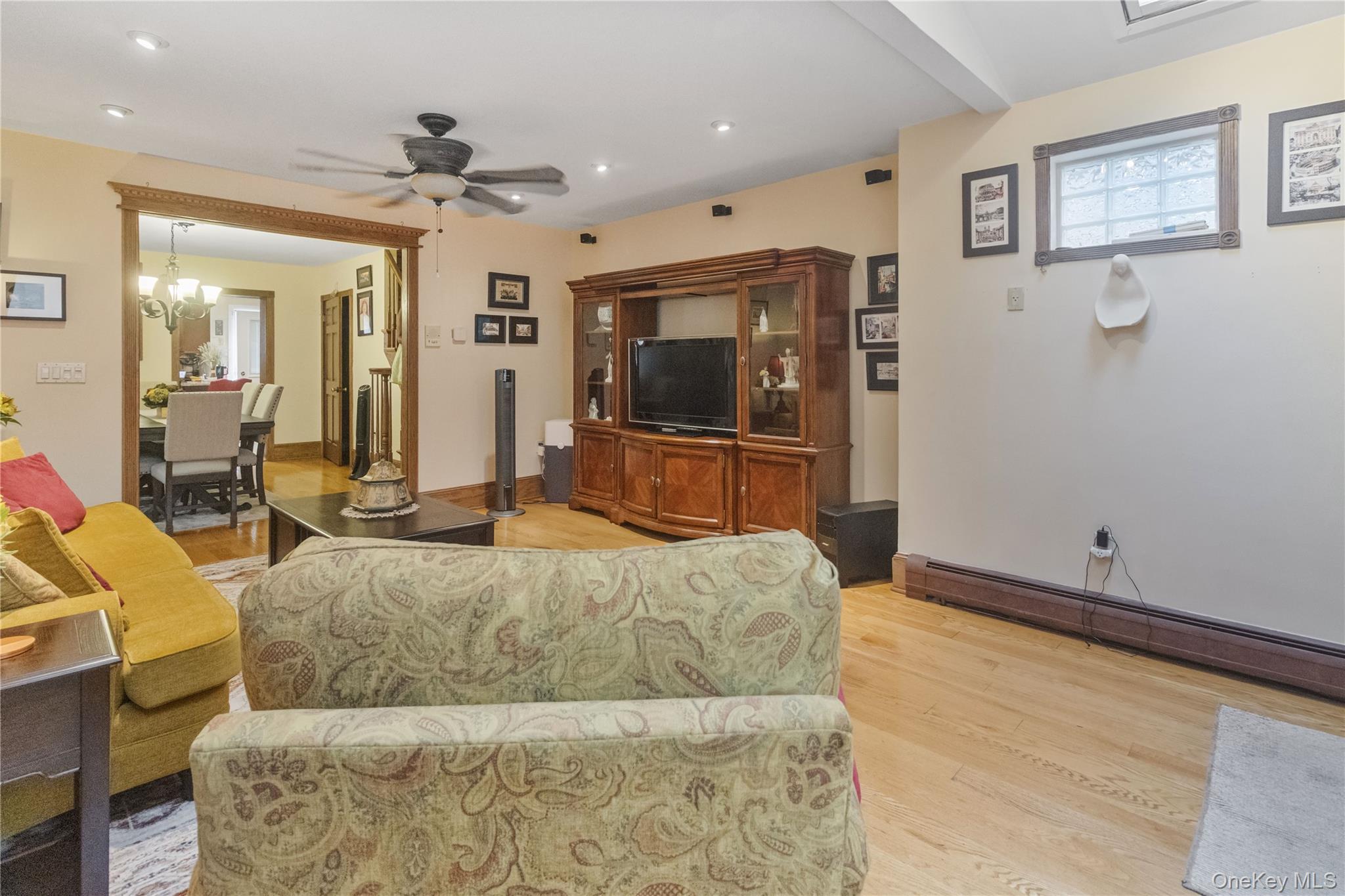 69-24 68th Place Queens, NY 11385 - Photo 5 of 26 a living room with a couch and a flat screen tv