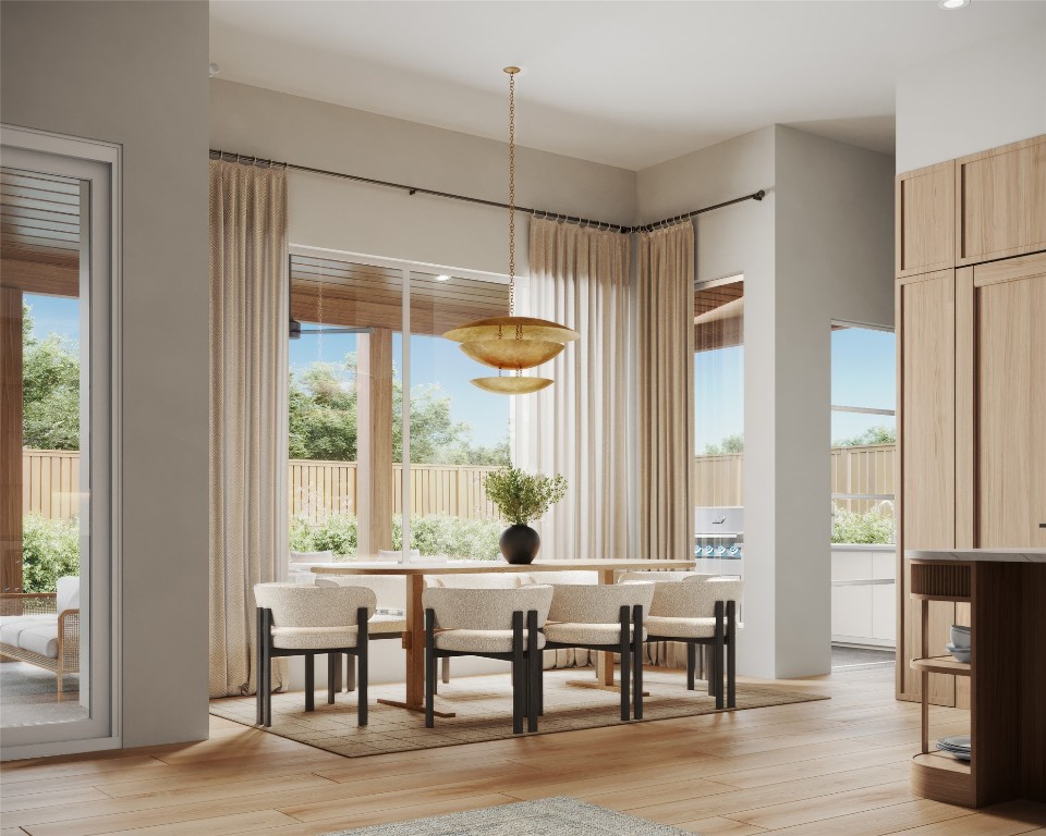 Adjacent to the kitchen and seamlessly integrated with the living and outdoor spaces, the dining room's generous windows frame picturesque pool views, creating an ideal setting for both intimate meals and grand entertaining