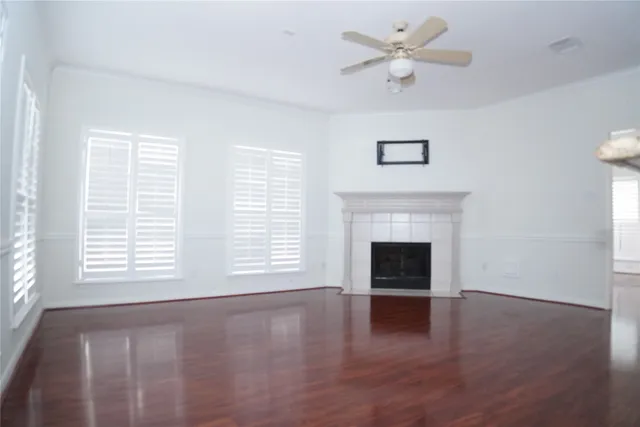 an empty room with windows and a fireplace