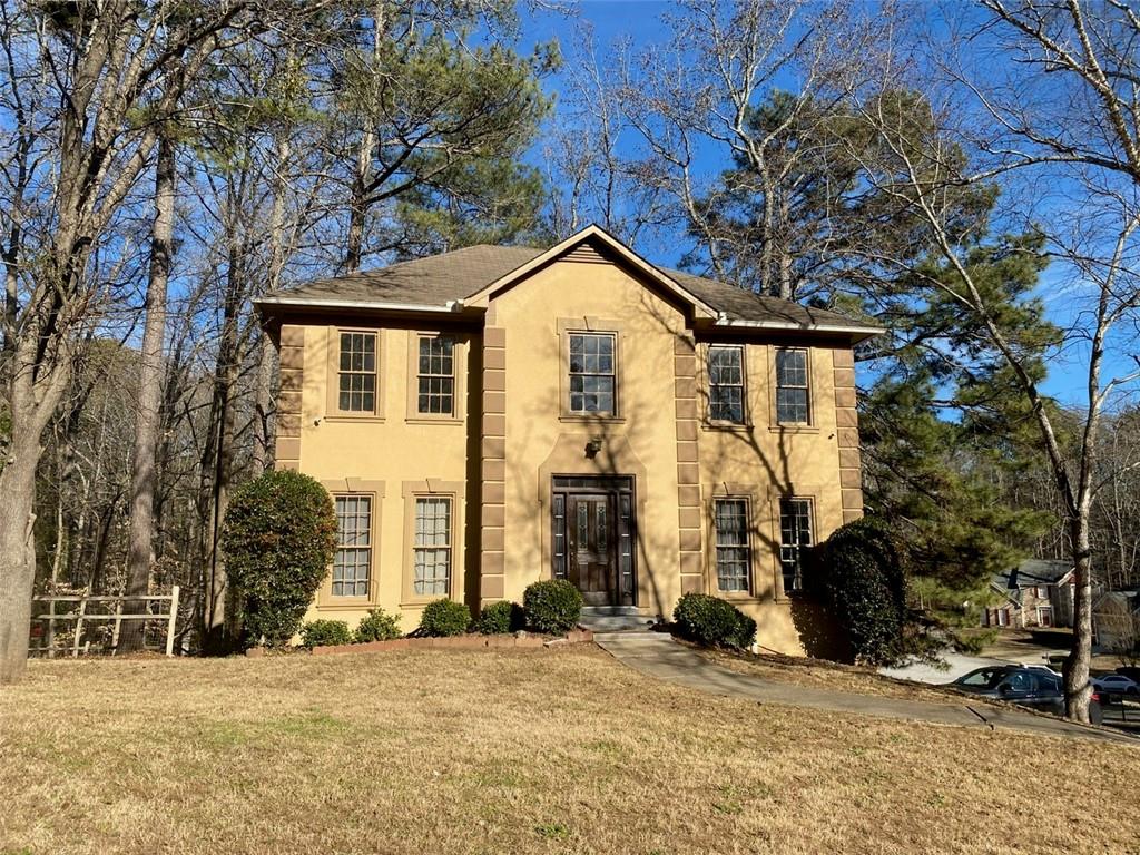 7592 Watson Kaye Stone Mountain, GA 30087 - Photo 1 of 1 a view of a house with large trees