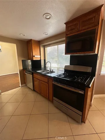 a stove top oven sitting inside of a kitchen