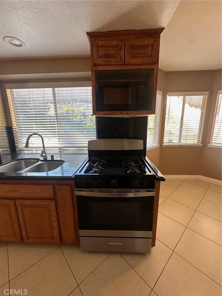 13470 Mallorca Lane Chino Hills, CA 91709 - Photo 15 of 44 a stove top oven sitting inside of a kitchen