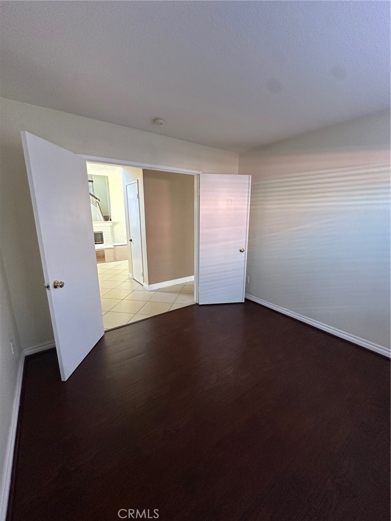 13470 Mallorca Lane Chino Hills, CA 91709 - Photo 21 of 44 a view of an empty room with wooden floor and a window